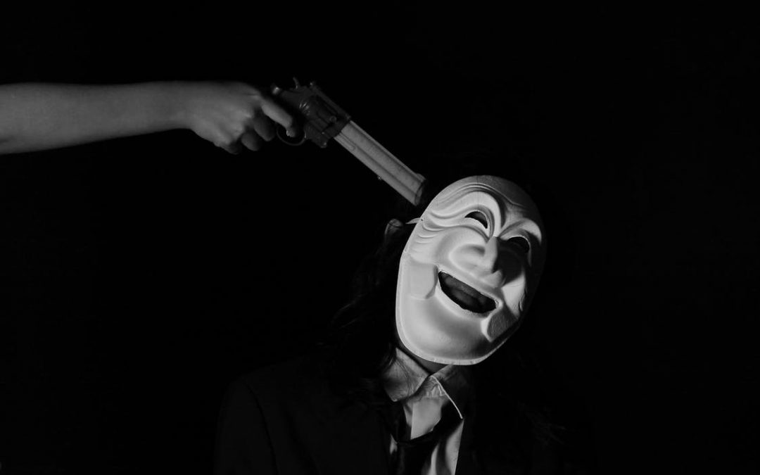 clown with gun at his head