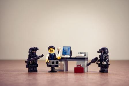 Toy figures: man beside computer and FBI